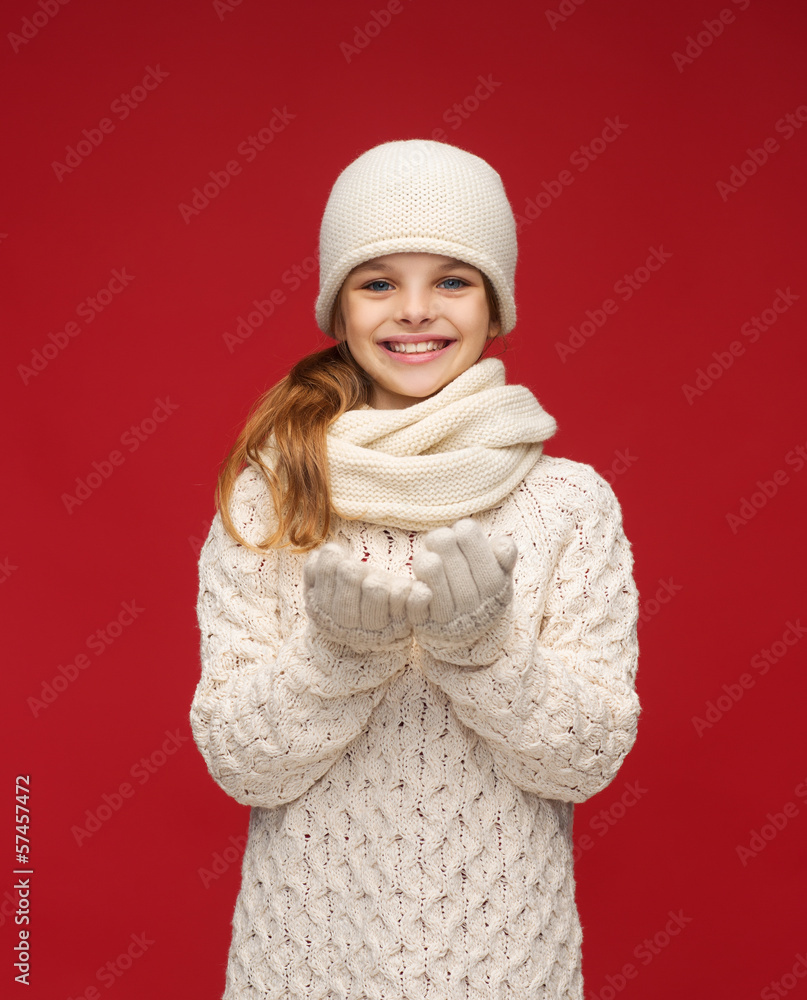 girl in winter clothes with something on palms girl in winter clothes with something on palms