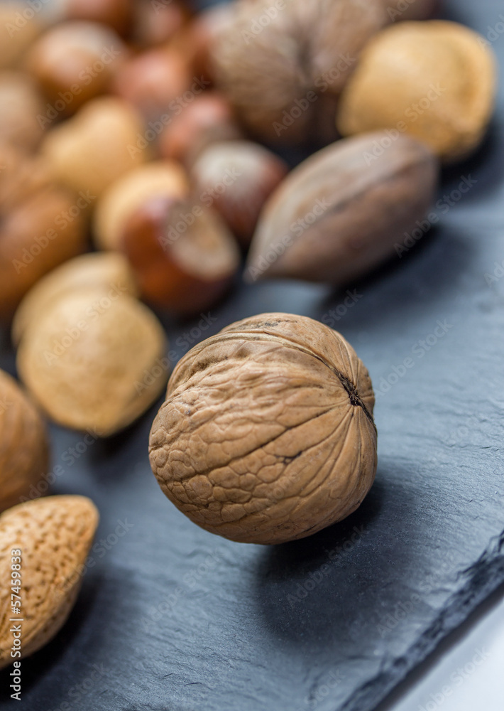 a walnut in front of a nut mixtur a walnut in front of a nut mixtur