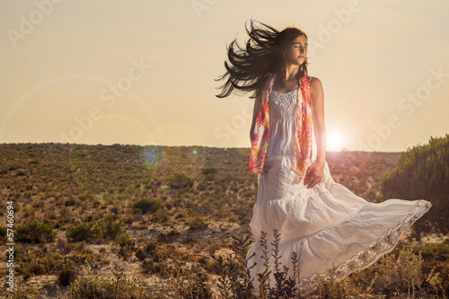  girl with a long white dress on the forest.