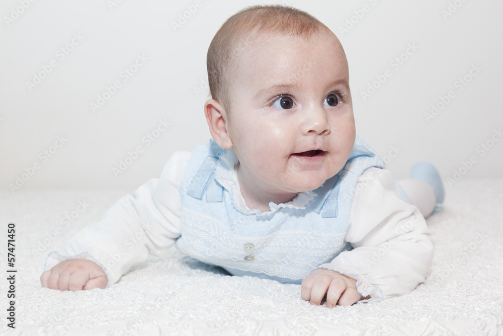 Cute baby lying on white blanket and smiling Cute baby lying on white blanket and smiling