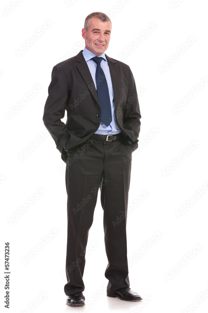 business man stands with hands in pockets business man stands with hands in pockets