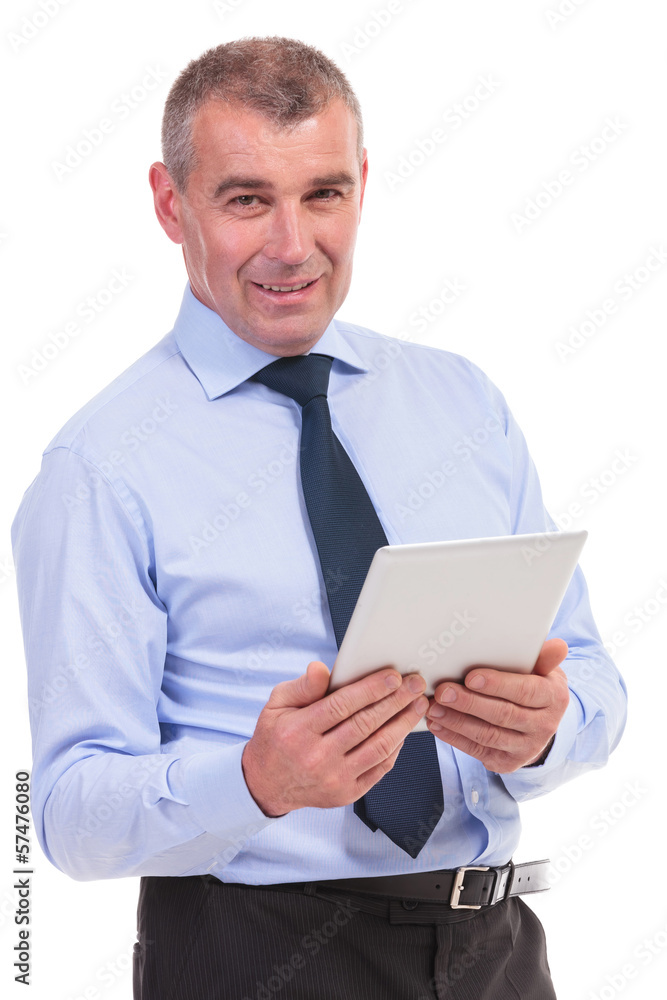 business man smiles at you with tablet in hand business man smiles at you with tablet in hand