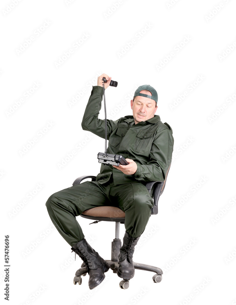 Man in workwear sitting with phone. Man in workwear sitting with phone.