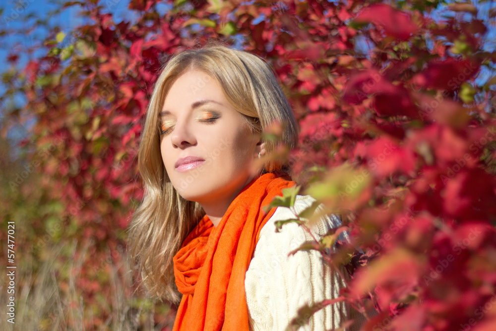 portrait of young beautiful woman dreaming in autumn park