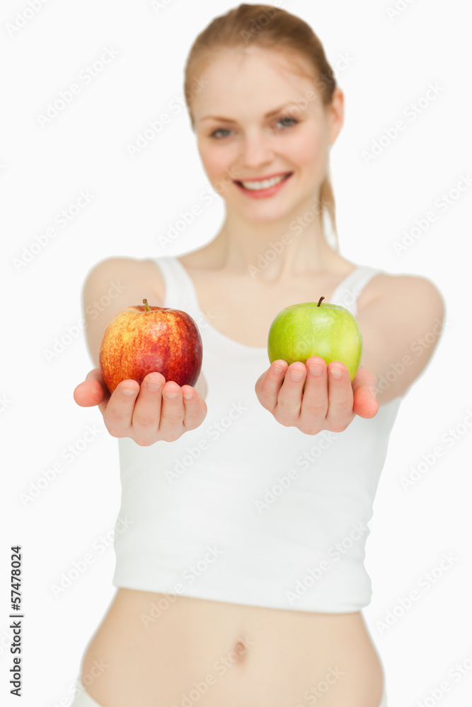 Cheerful woman presenting two apples Cheerful woman presenting two apples
