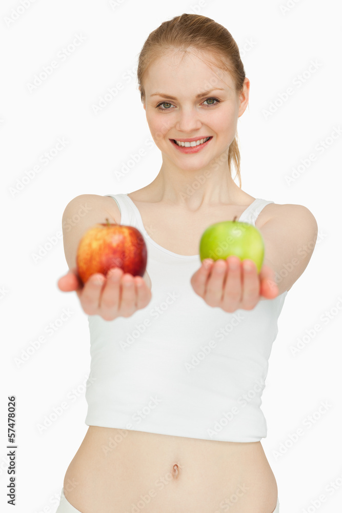 Joyful woman presenting two apples Joyful woman presenting two apples
