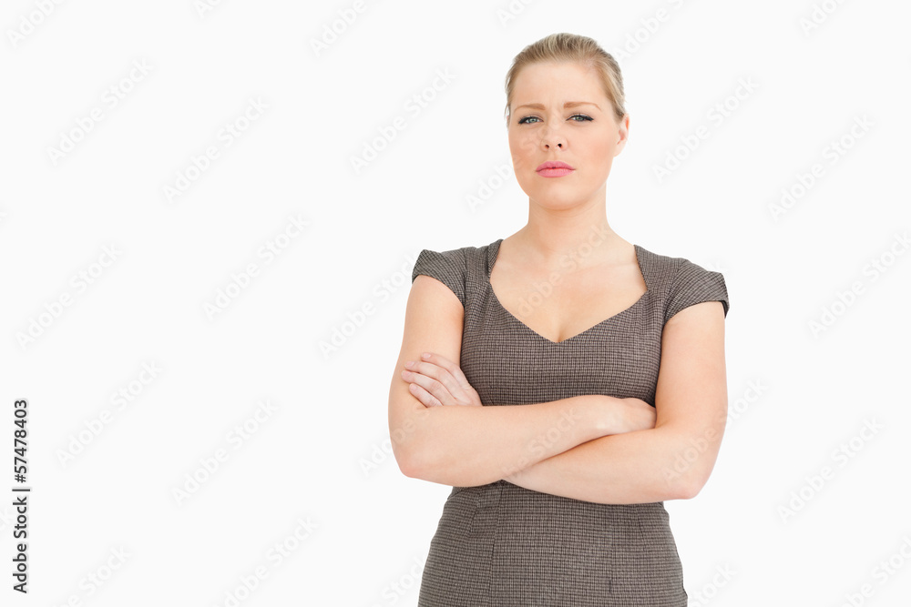 Uneasy woman standing with her arms crossed Uneasy woman standing with her arms crossed