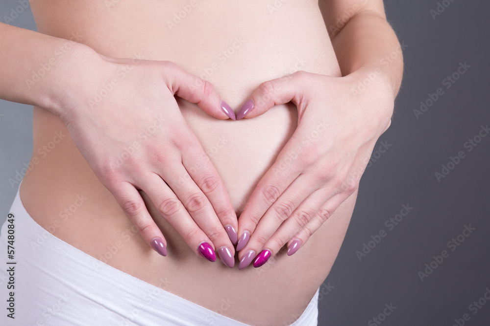 pregnant woman with hands in the shape of a heart