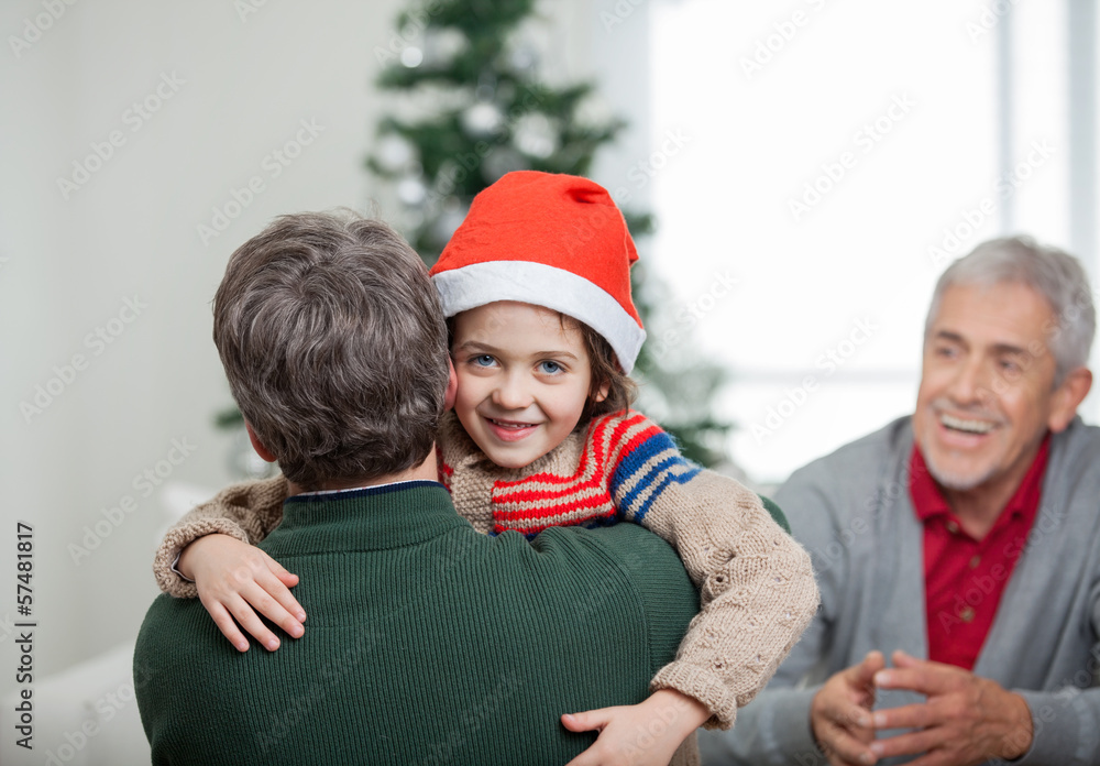 Happy Boy Embracing Father During Christmas Happy Boy Embracing Father During Christmas