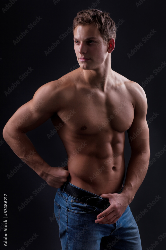 Muscle sexy naked young man posing in jeans