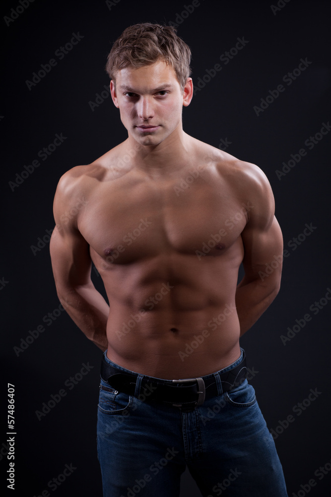 Fototapeta premium Muscle sexy naked young man posing in jeans