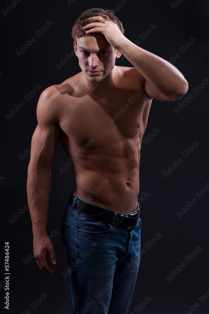 Muscle sexy naked young man posing in jeans