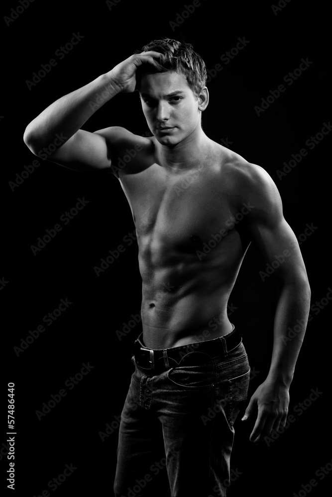 Muscle sexy naked young man posing in jeans