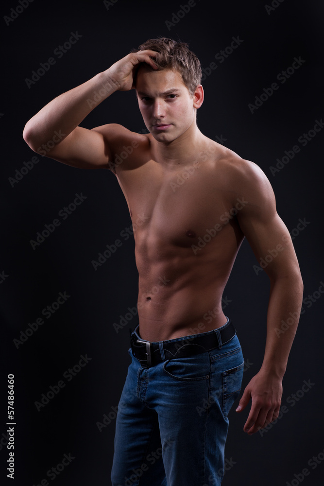Fototapeta premium Muscle sexy naked young man posing in jeans