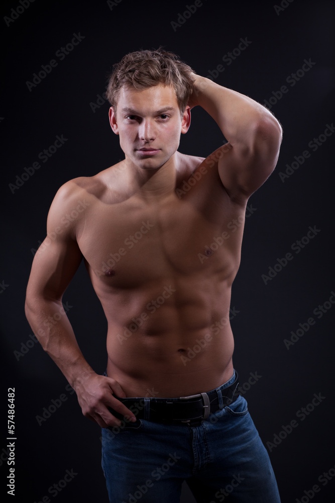 Muscle sexy naked young man posing in jeans Muscle sexy naked young man posing in jeans