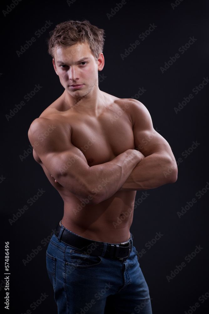 Muscle sexy naked young man posing in jeans