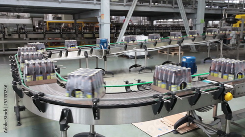 The brewery. Packaging of bottles moving on conveyor