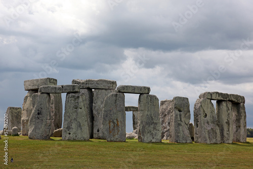 Stonehenge historic site on green grass under blue sky. Stonehen