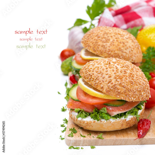 delicious burgers with smoked salmon and vegetables on board