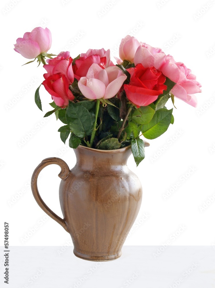 pink roses in brown ceramic jug