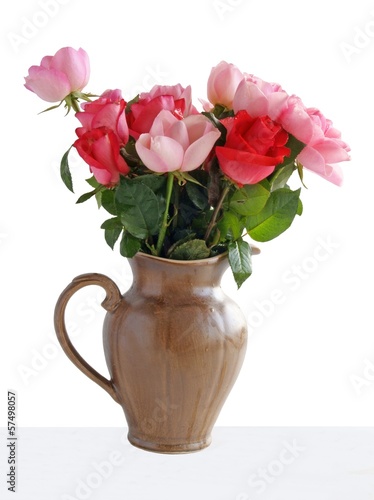 Fototapeta Naklejka Na Ścianę i Meble -  pink roses in brown ceramic jug