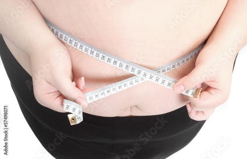 Obese woman measure her waist belly. photo