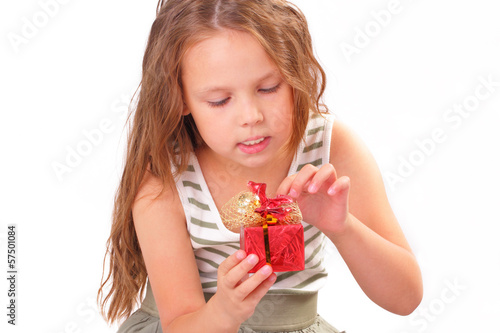 Attractive little girl with a gift for St. Valentine's Day