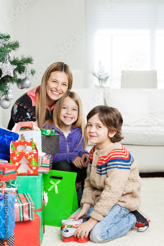 Mother And Children With Christmas Gifts