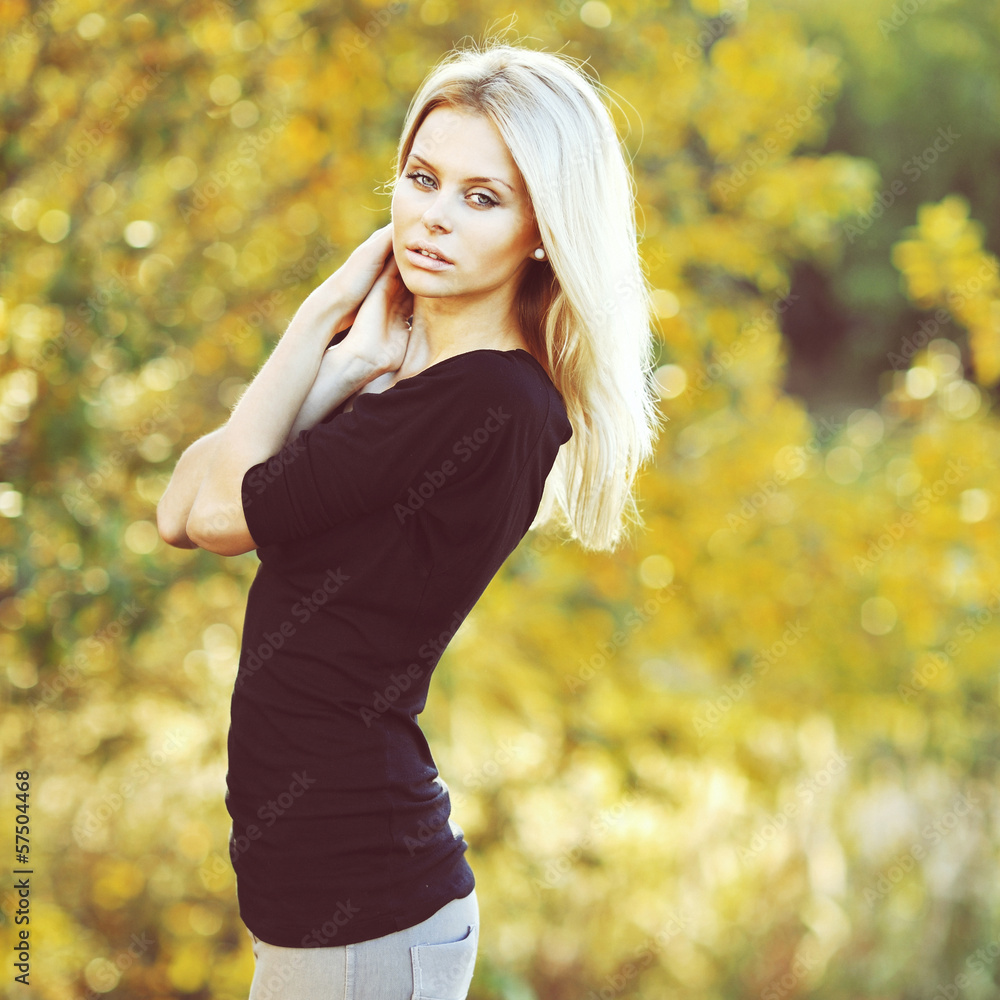 Young beautiful blonde woman posing in a summer park - sunset Young beautiful blonde woman posing in a summer park - sunset