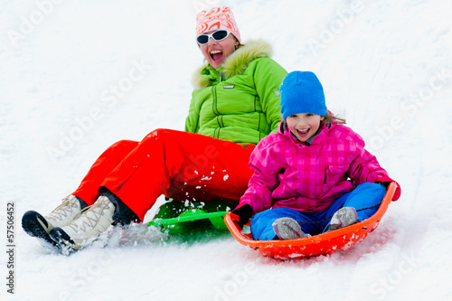 Winter fun - family sledding at winter time