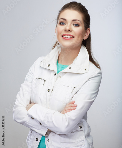 Casual style young woman posing on isolated studio background.