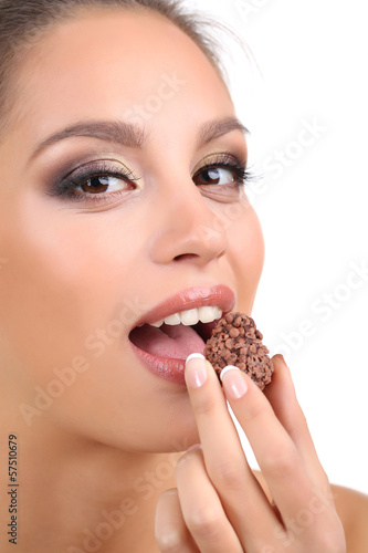 Portrait of beautiful young girl with chocolate candy isolated