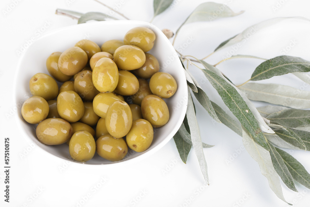 Olives in bowl with branch isolated on white Olives in bowl with branch isolated on white