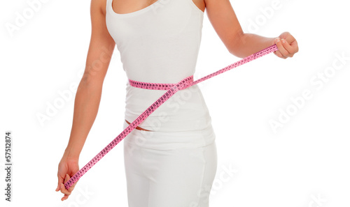 Woman with a tape measure measuring her waist