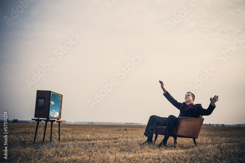 young men with TV in summer field