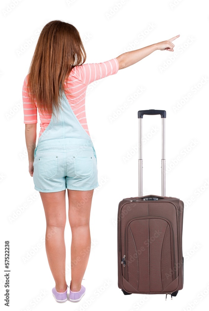 Back view of traveling pointing woman with suitcase Back view of traveling pointing woman with suitcase