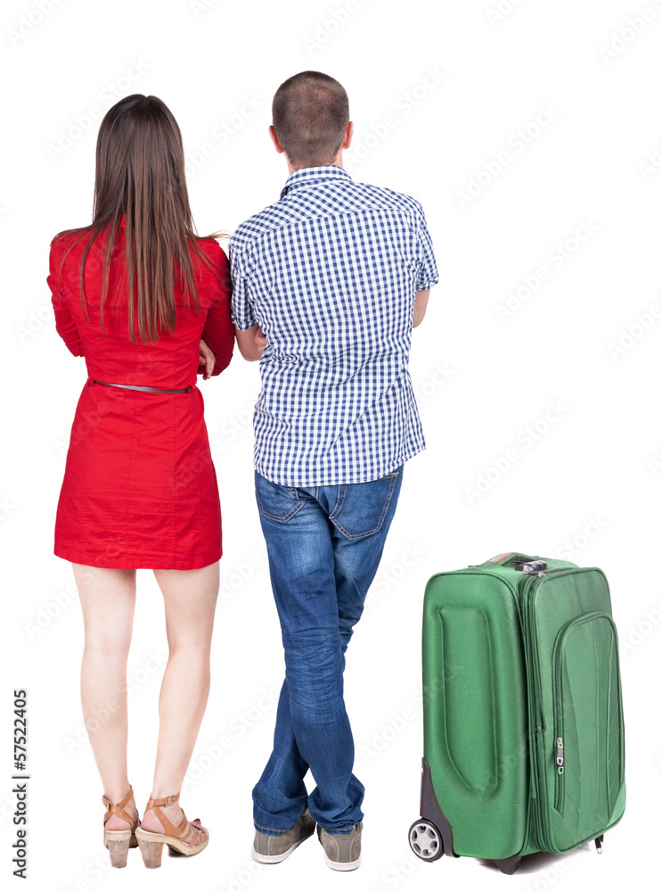 Back view of young couple traveling with suitcas . Back view of young couple traveling with suitcas .