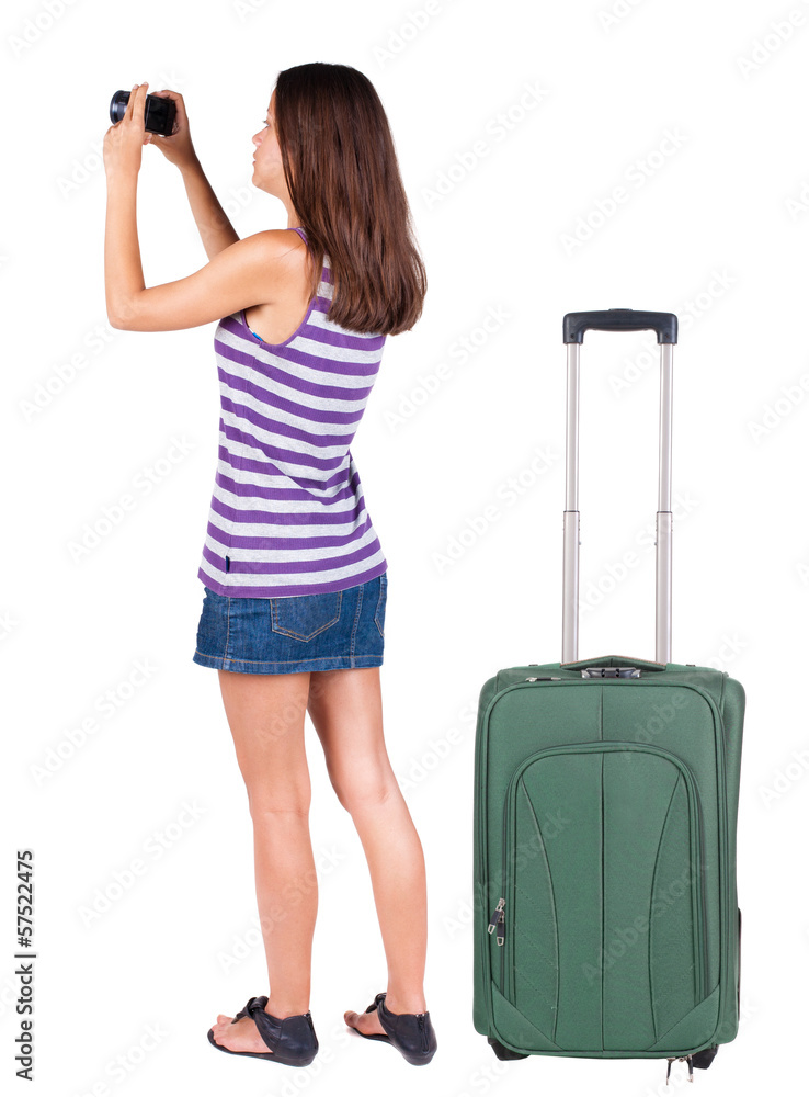 Back view of woman photographing traveling with suitcas. Back view of woman photographing traveling with suitcas.