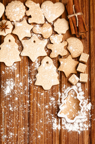 Homemade christmas cookies and spice on wooden background