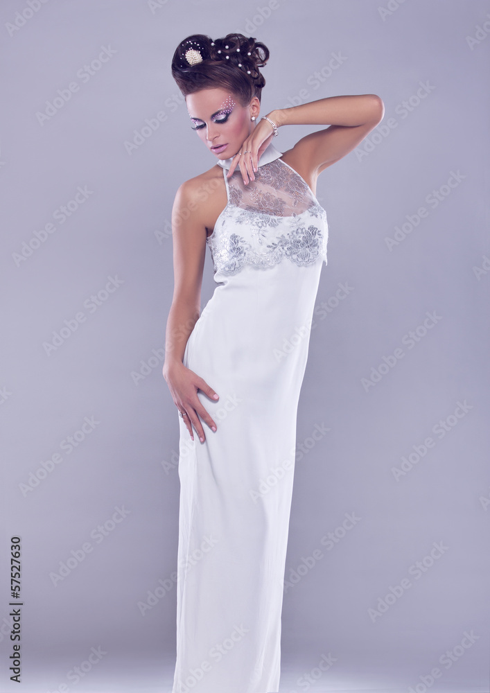 Young and beautiful bride standing in studio Young and beautiful bride standing in studio