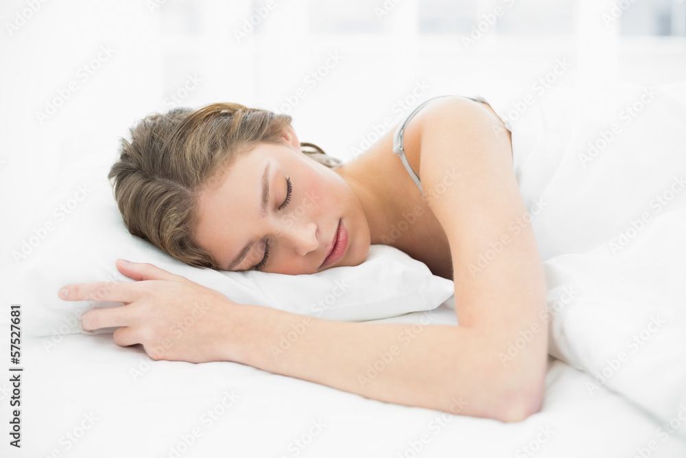 Relaxed young woman sleeping under the cover on her bed Relaxed young woman sleeping under the cover on her bed