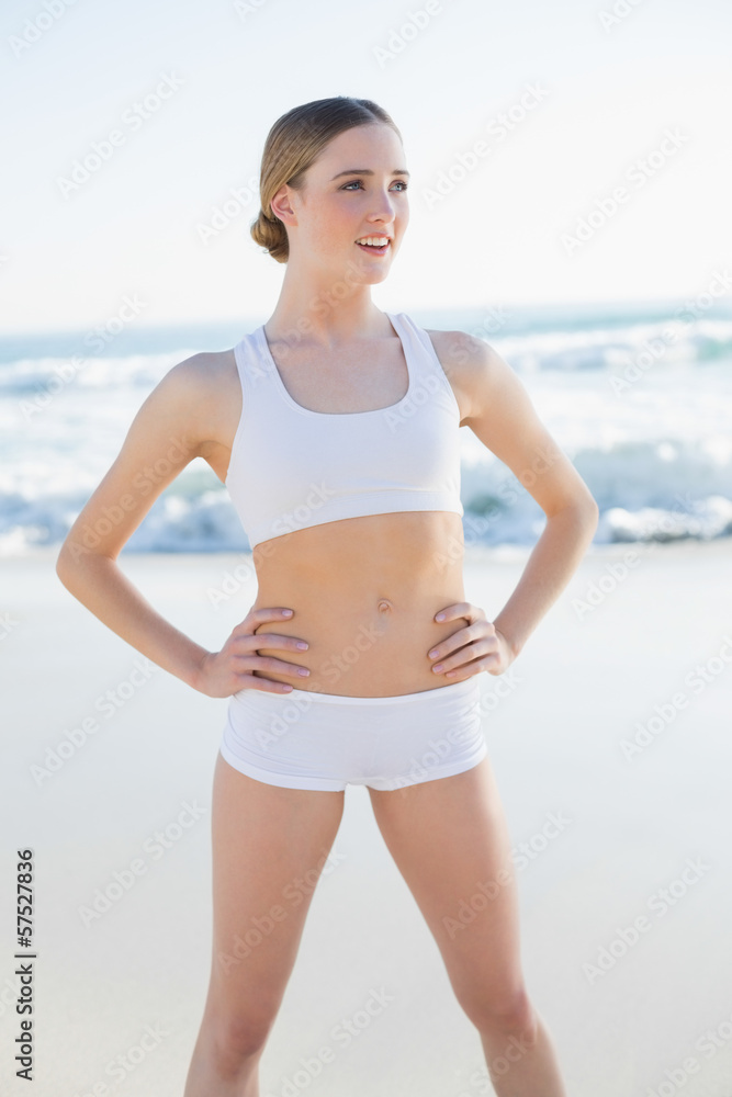 Content slender woman standing hands on hips looking away Content slender woman standing hands on hips looking away