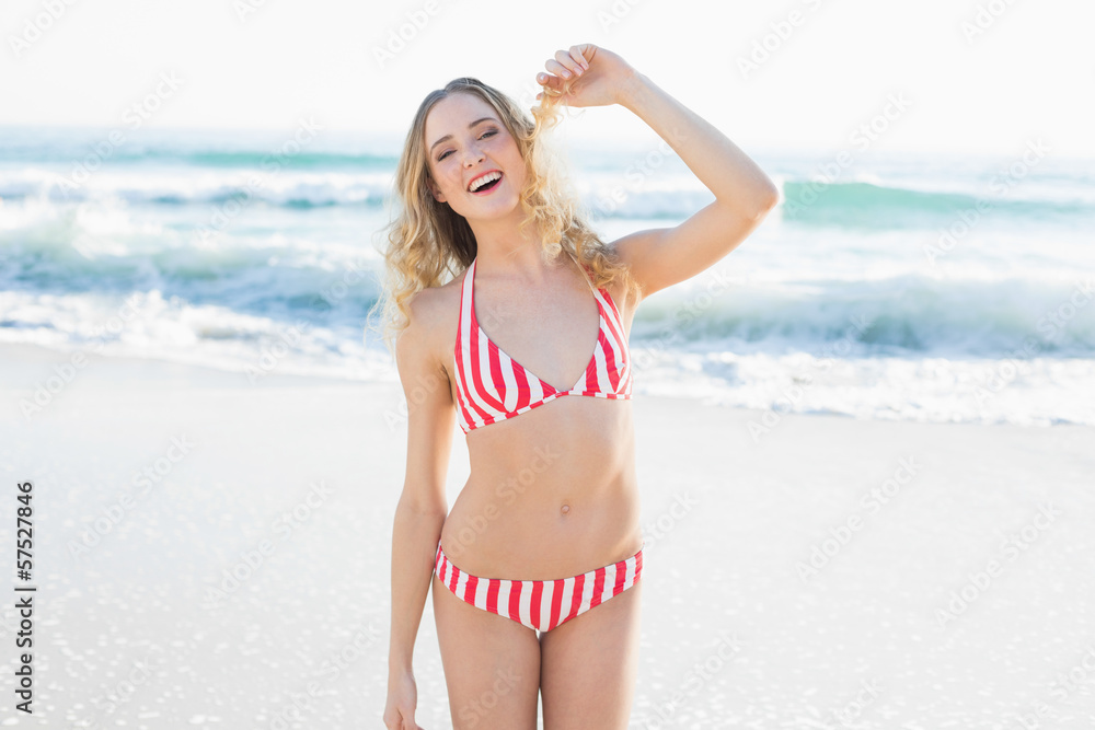 Amused blonde woman posing on the beach Amused blonde woman posing on the beach