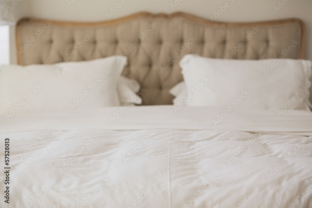 Empty bed with white duvet cover