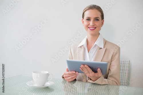 Lucky stylish businesswoman using tablet