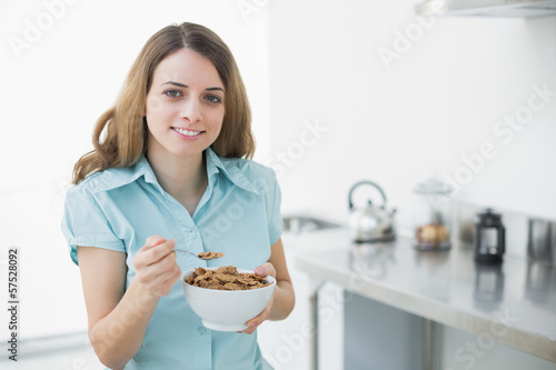 Content woman showing a bowl filled with cereals
