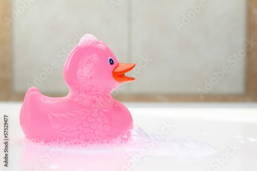 Fotografie Pink rubber duck in bath foam