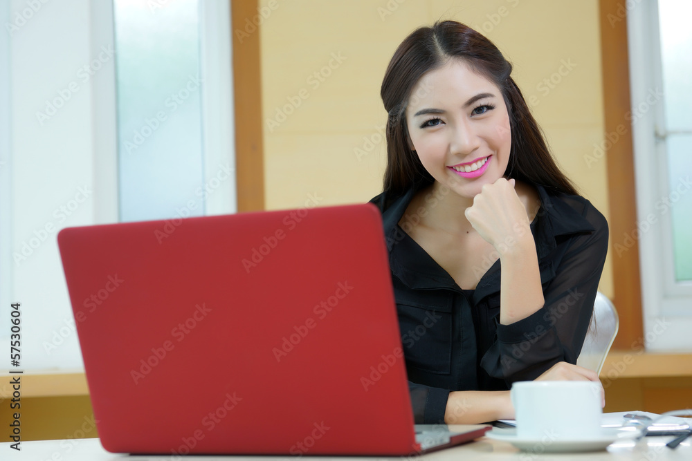 Young pretty business woman with notebook in the office Young pretty business woman with notebook in the office