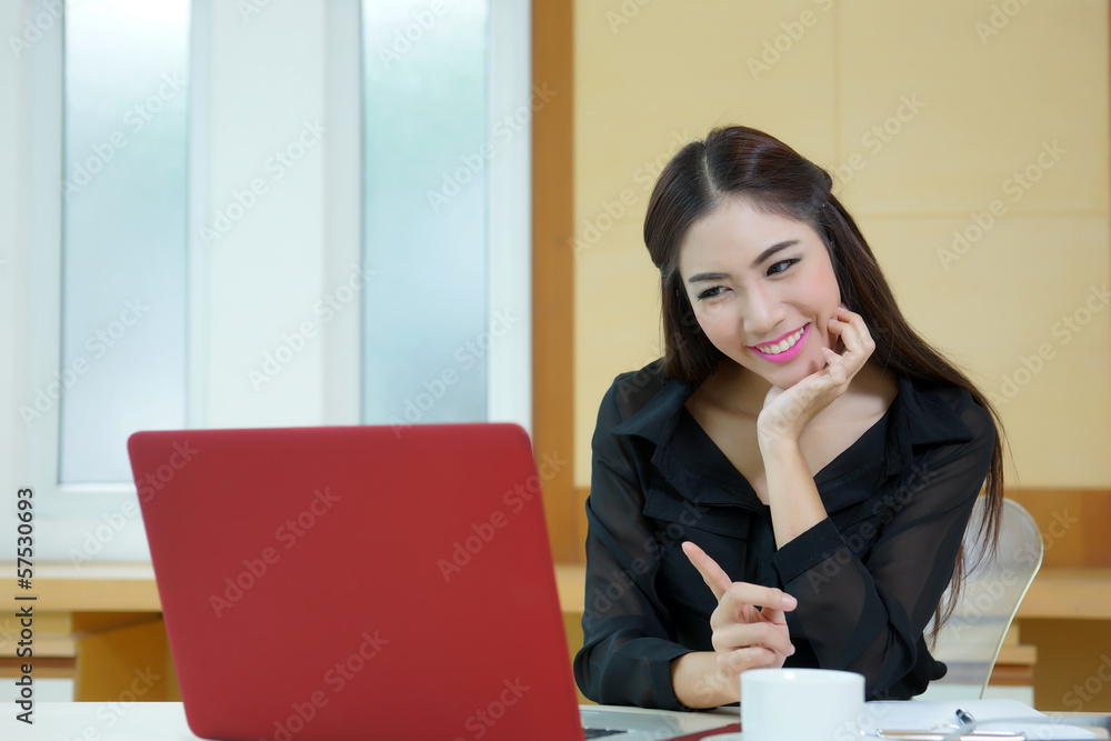 Young pretty business woman with notebook in the office Young pretty business woman with notebook in the office