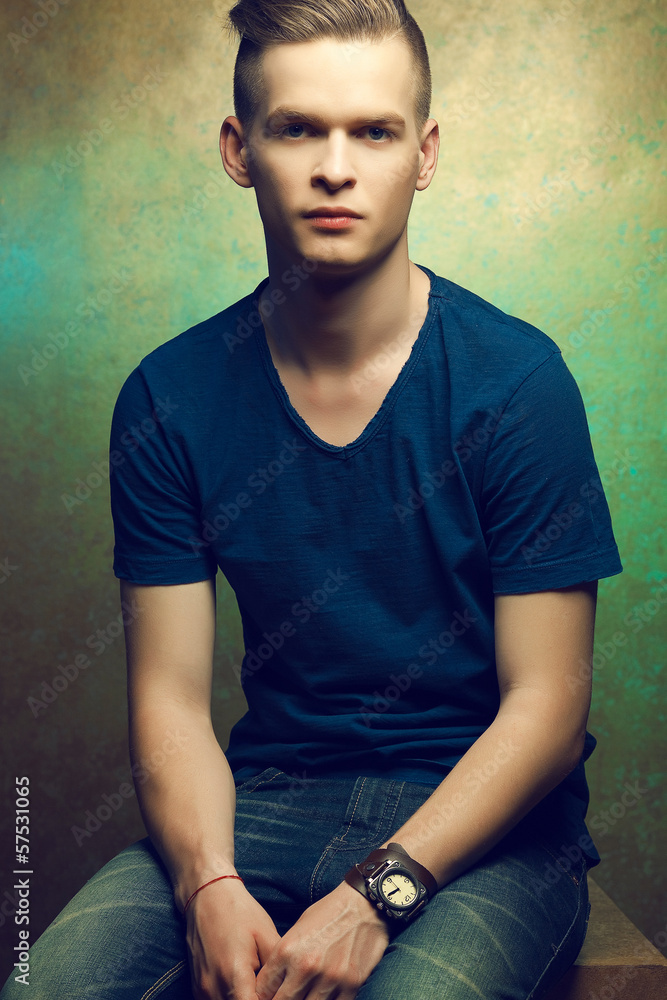 Obraz premium Portrait of a young man with very handsome face in blue t-shirt